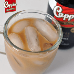 Image of cold brew coffee in a glass next to a bottle of Cappio Cold Brew Coffee.